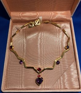 YVES SAINT-LAURENT necklace gilded metal with faceted stones and a central heart stone